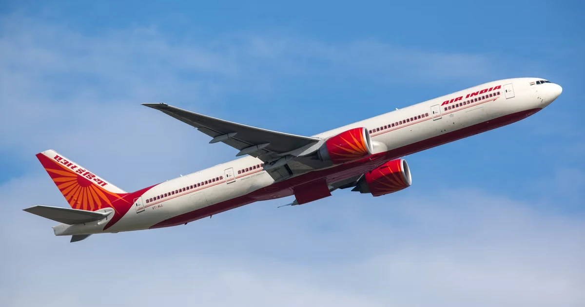 Air India passenger aircraft climbing into clear skies during an international flight to Delhi route.