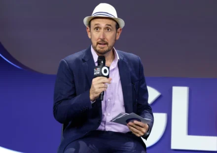 Randall Lane speaks into a microphone at the Global Citizen Now event.