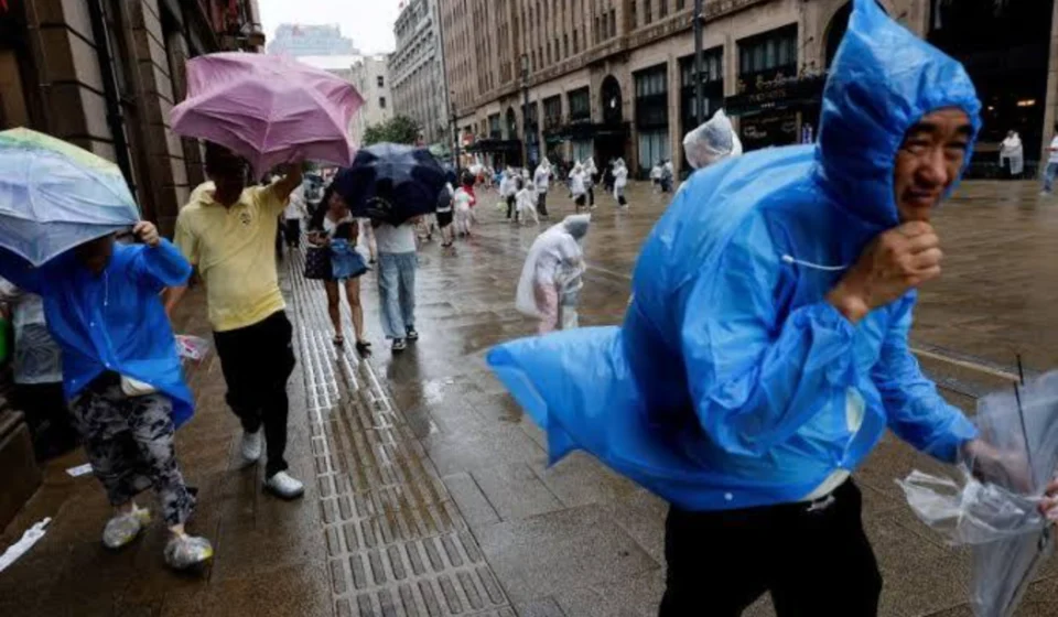 Typhoon Dolphin Forces Evacuation of Over 1 Million People in Eastern China People in raincoats and umbrellas walk through flooded streets as a typhoon hits coastal China today.