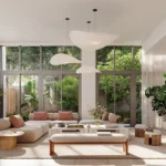 Bright wellness inspired living room with floor to ceiling windows, indoor plants, natural light.