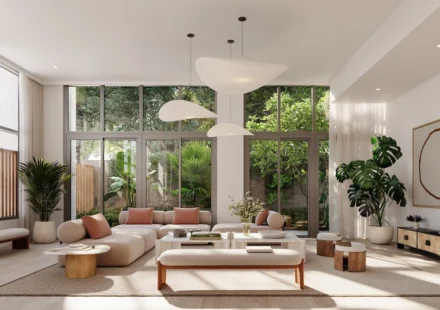 Bright wellness inspired living room with floor to ceiling windows, indoor plants, natural light.